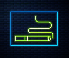 Glowing neon line Cigarette icon isolated on brick wall background. Tobacco sign. Smoking symbol. Vector