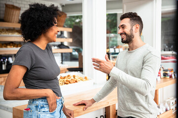 Male entrepreneur discussing with co-owner at pastry