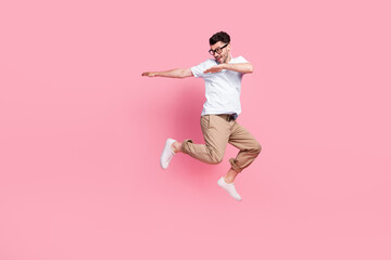 Full length photo of positive nice man interested look empty space dressed stylish clothes empty space isolated on pink color background