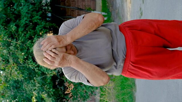grandmother has a headache on the road. Selective focus.