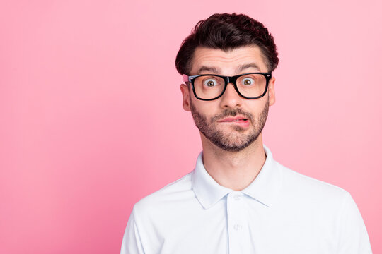 Closeup photo of young handsome funny nervous guy wear white polo t-shirt bite lips empty space proposition oops sorry isolated on pink color background