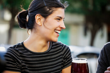 Close-up of smiling young woman sitting outdoors