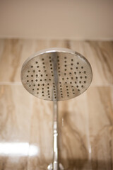 Large round shower head inside new shower cabin. Low angle view, no water, no people