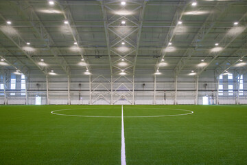 A new empty European sports hall for playing football at any time of the year. The football field...