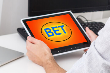 man placing bet with tablet computer, closeup