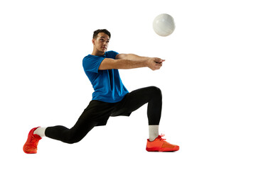 Dynamic portrait of male volleyball player training with ball isolated on white studio background....