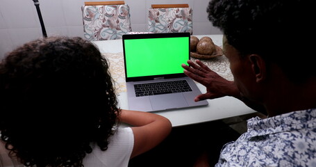 Father and child daughter looking at computer laptop screen, chroma key