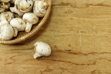 Champignon mushrooms on wood background