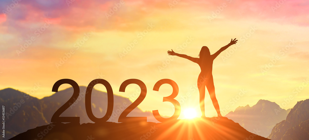 Wall mural New Year 2023, New Start motivation inspirational quote message. Confident happy woman meets dawn in mountains for new year 2023. New Start motivation inspirational quote message on silhouette woman