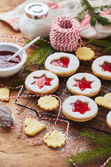 Fototapeta na wymiar Classic Linzer Christmas Cookies with raspberry or strawberry jam on wooden table