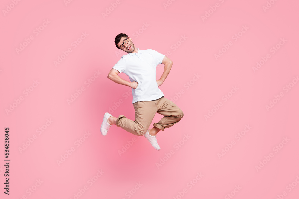 Poster Full length photo of cheerful man jump enjoy travel vacation holiday relax rest without work empty space isolated on pink color background