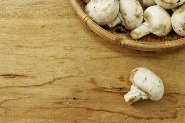 Champignon mushrooms on wood background