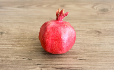 Red ripe pomegranate on wooden background
