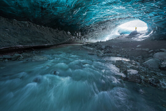 Traveler inside ice cave in daytime
