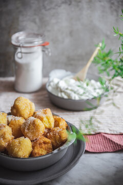 Bowl with nun's puffs cheese bites on table