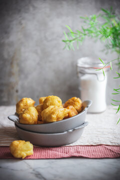 Bowl with nun's puffs bites on table