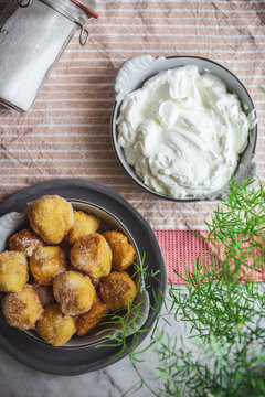 Bowl with nun's puffs cheese bites on table