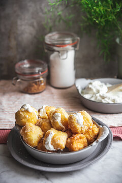 Bowl with nun's puffs cheese bites on table