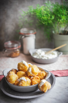 Bowl with nun's puffs cheese bites on table