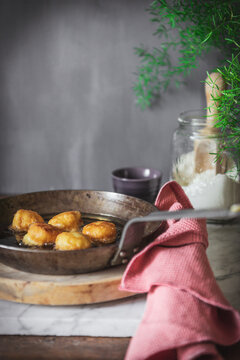 Pan with oil frying nun's puffs bites