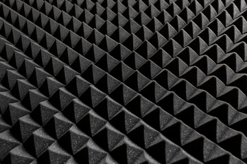 Acoustic insulation foam panel. Studio audio soundproofing. Dark background in pyramidal shape.  