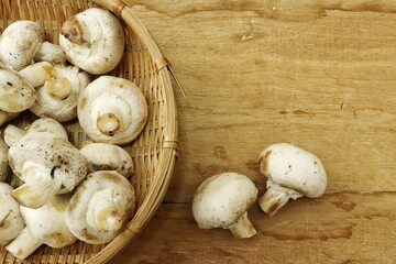 Champignon mushrooms on wood background