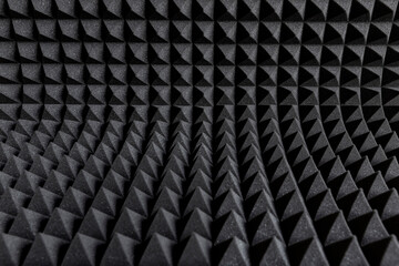 Acoustic insulation foam panels forming a pattern. Audio soundproofing in studio. Dark background.