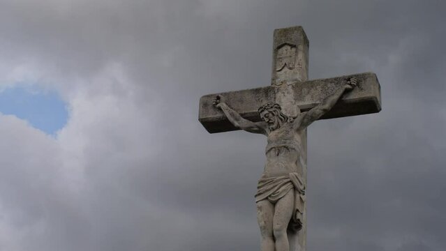 Stone Statue Of Christ On A Cross 4K Clouds time Lapse