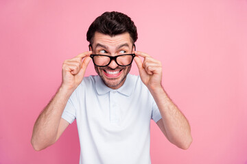 Closeup photo of young attractive handsome funny guy wear glasses toothy smile look empty space curious good offer isolated on bright pink color background