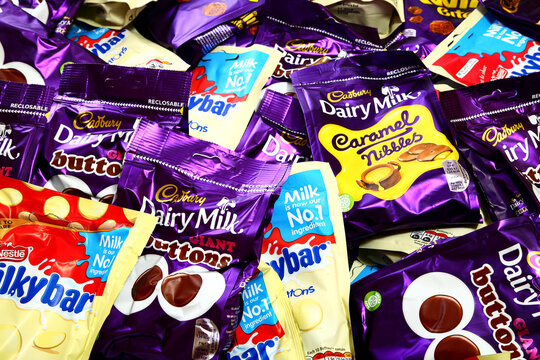 Packets of various chocholate snacks including cadbury twirl bites,dairy milk giant buttons,caramel nibbles and nestle milky bar giant buttons