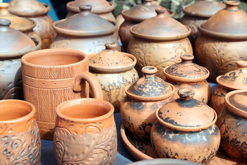 Fototapeta na wymiar clay mug surrounded by other dishes. handmade