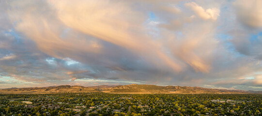 early morning over Fort Collins and foothills of Rocky Mountains in northern Colorado, aerial...