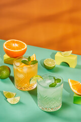 Multi-colored cocktails in glasses of different shapes on colored backgrounds with hard shadows