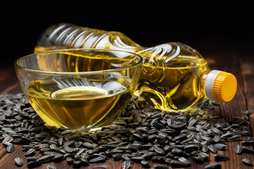 Organic sunflower oil in a glass bowl and bottle with sunflower seeds.