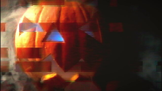 Scary background for Halloween celebration. Digital glitch. A pumpkin with a face cut out is smoking.