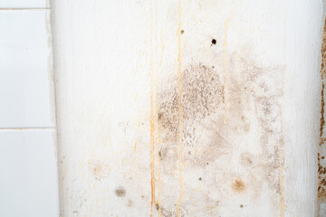 View of a wall with rain water seeping into the wall causing damage and peeling paint