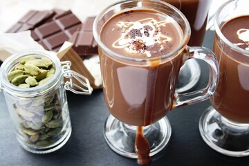 Hot chocolate drink with cardamom in it and along with some chocolate.
