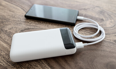 high angle view of smartphone charging on portable high capacity power bank