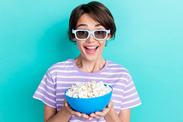 Portrait of nice cute pretty girl with bob hairdo wear striped t-shirt holding popcorn tv show isolated on turquoise color background