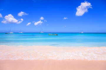 Fototapeta na wymiar Tropical caribbean beach with sailboats and boat, Punta Cana, Dominican Republic