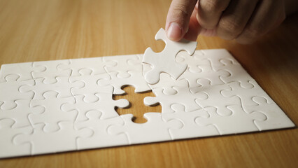 Pieces of jigsaw on palm Pieces of jigsaw puzzle in businessman hands