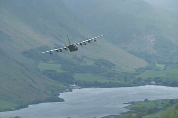 Fototapeta na wymiar C-130 Hercules transport aircraft low level flying training in mach loop valley Wales