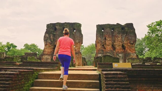 Following a female tourist walking up the stairs to King Parakramabahu's Royal Palace in the ancient city of Polonnaruwa, Sri Lanka