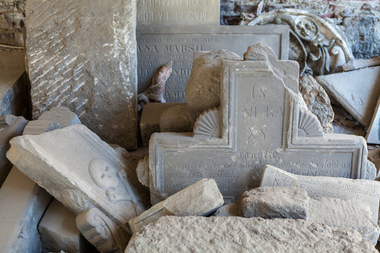 Heaps of stones with inscriptions in Pelus Castle, broken gravestones and carved bas relief.