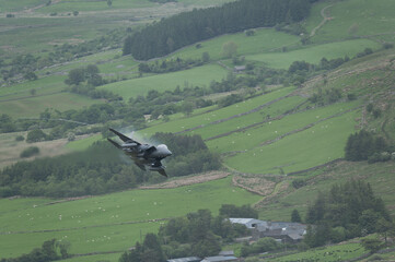 USAF F15 Eagle flying through Mach Loop in Wales at low level during flying training mission
