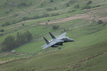 USAF F15 Eagle flying through Mach Loop in Wales at low level during flying training mission