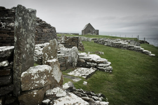 Ancient houses and stones in the Broch of Gurness, an Iron Age settlement on Orkney.
