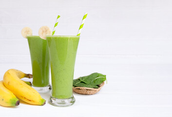 Banana mix spinach apple fresh cocktail smoothies  fruit juice beverage healthy the taste yummy in glass drink episode good morning on wooden background from the top view.