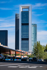 Madrid downtown business towers low angle view from urban transport interchange. City center life