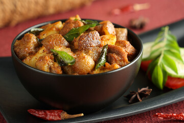 Spicy hot meat curry from Kerala India. Pork pig masala curry vindaloo. Indian food served rice,...